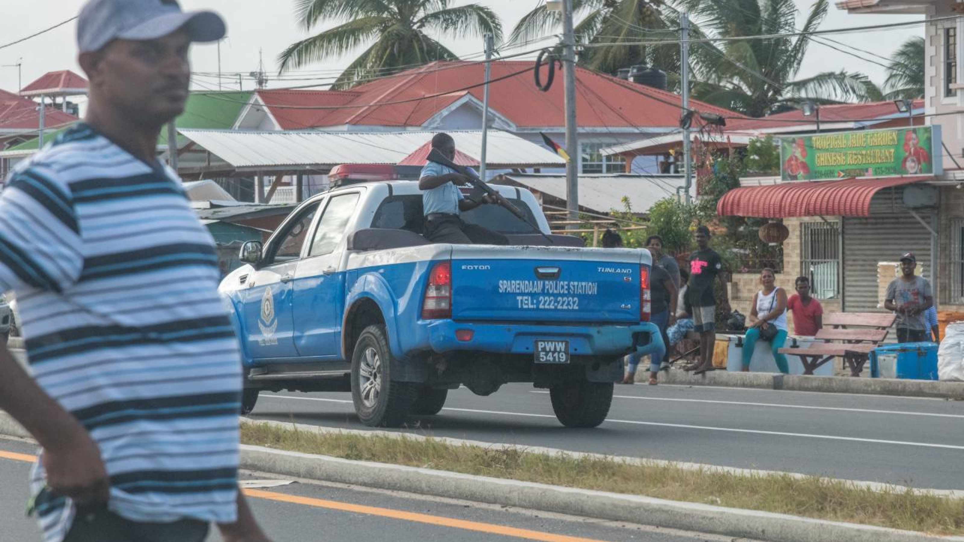 A policeman on a pickup truck carrying an assault gun during the protests.